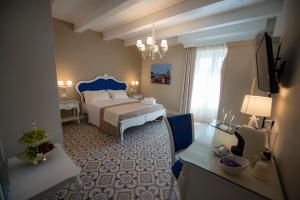 Voodi või voodid majutusasutuse Sui Generis Tropea Luxury Rooms toas