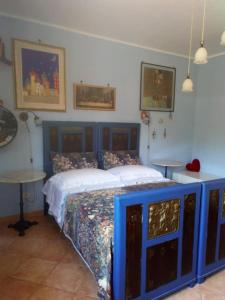 a bedroom with two beds and a table in it at Prospettiva Polignano in Polignano a Mare
