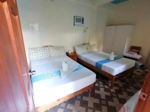 a room with two beds in a room at Mariner's Pension House in Puerto Princesa City +26 photos