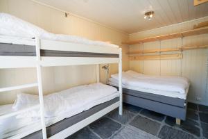 two bunk beds are in a small room at Røde Kors ground floor in Brunstad