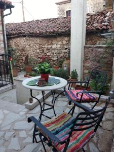 a table and chairs sitting on a patio at Proselinos in Dimitsana