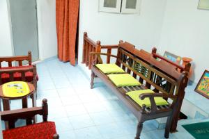 a room with two wooden benches and a table at Nisala Guest -Galle Dutch Fort in Galle