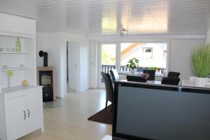 a kitchen and living room with a table and chairs at Ferienwohnung Abersfelder mit Balkon in Wildflecken