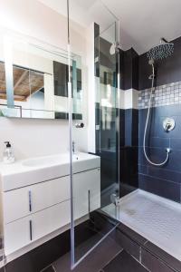 a bathroom with a glass shower and a sink at La casa del reloj in Estepona