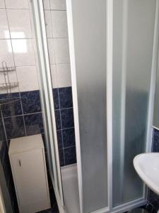 a bathroom with a shower and a sink at Luka 3 in Podgora