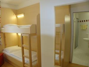 A bed or beds in a room at Jugendgästehaus St. Gilgen