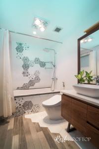 a bathroom with a toilet and a shower and a sink at Irest Apartment in Hanoi +43 photos