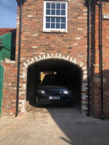a black car is parked in a brick tunnel at The Lodgings in Beverley