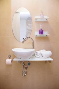 a bathroom with a white sink and a mirror at Apartments4you Etsel in Bat Yam