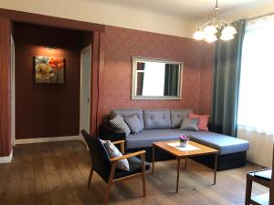 a living room with a couch and a table at Allika Apartments in Tallinn