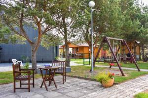 a park with a table and chairs and a playground at Nameliai Gulbės takas in Šventoji