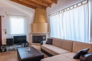 a living room with a couch and a fireplace at HOUSE NEXT TO THE SEA in Ermioni