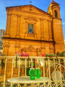 a table in front of a building with a church at amurimè in Porto Empedocle