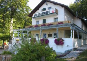 a building with a sign on top of it at Waldgasthaus in Hochburg