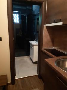a bathroom with a sink and a toilet and a sink at Stan na Dan Apartman D Lux Jacuzzi in Kragujevac