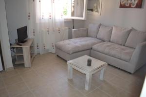 ein Wohnzimmer mit einem Sofa und einem Tisch in der Unterkunft Melissaratos Studios in Argostoli