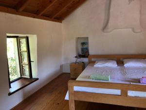 a bedroom with a wooden bed and a window at Holiday home Villa Kastel in Korčula