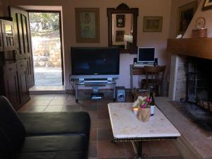 a living room with a tv and a fireplace at Holiday home Villa Kastel in Korčula