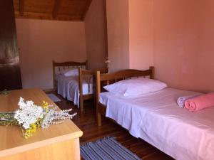 a room with two beds and a table with flowers on it at Holiday home Villa Kastel in Korčula +30 photos