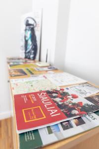 a table with a magazine on top of it at Modern 2-room flat in the city center in Šiauliai
