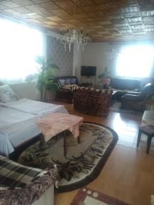 a living room with a bed and a table at Privát u Ivana in Štrba