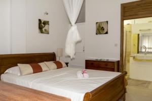 a bedroom with a bed with two towels on it at La Batie selfcatering Apartment in Beau Vallon