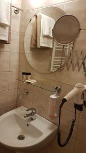 a bathroom with a sink and a mirror at Hotel Slunce in Rýmařov