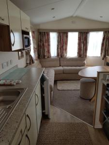 a small kitchen and living room in a caravan at Caravan Willerby Gold Star in Looe