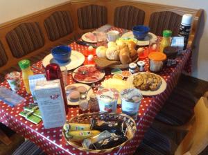 a table with a red and white table cloth with food on it at Ferienhaus Schäfer in Flattnitz