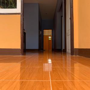 an empty room with a wooden floor and a hallway at Home of River Kwai in Kanchanaburi