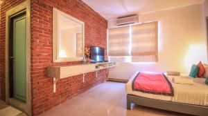 a bedroom with a bed and a window at Clock Inn Dehiwala in Dehiwala