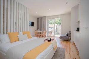 Un dormitorio con una cama grande y una mesa. en Liiiving in Porto - Charming Downtown Delight, en Oporto