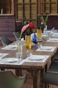 a wooden table with plates and wine glasses on it at Ataraxia in Bastimentos