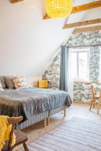 a bedroom with a king sized bed and a window at KaksTeist Apartments in Haapsalu