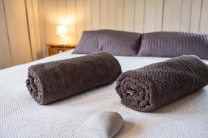 a bed with two towels and a heart on it at Suite l'Escoundudo in Aix-en-Provence