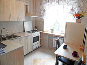 a kitchen with a sink and a stove top oven at Apartment on Sobornaya 58 in Khmelnytskyi