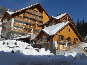 a large building with snow in front of it at VAUJANYLOCATIONS- Chalet du Verney in Vaujany