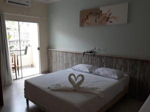 a bedroom with a bed with two hearts on it at Areia do Atlantico Hotel in Porto Seguro