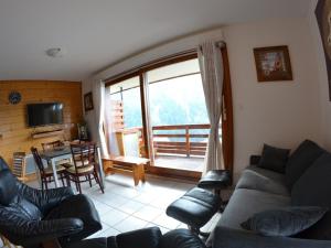 a living room with a couch and a table at VAUJANYLOCATIONS- Chalet du Verney in Vaujany