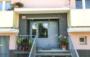 a front door of a pink building with potted plants at Smart Home Žilina in Žilina