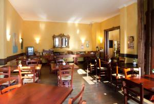 a dining room with wooden tables and chairs at Hotel Weidenhof in Plettenberg