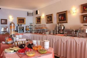 a buffet table with plates of food on it at Hotel Paraíso Del Mar in Nerja