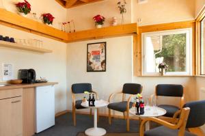 a room with two tables and chairs and a window at Hotel Weidenhof in Plettenberg