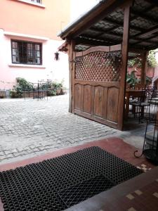 an open gate to a patio with a table and chairs at Hotel St-Antoine in Antananarivo