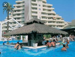 a group of people in a swimming pool at a hotel at Benalbeach JR Suite in Málaga