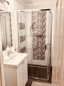 a bathroom with a sink and a shower at Heroes’ Residence II in Budapest