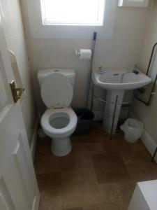 a bathroom with a toilet and a sink at THE CHADWICK in Skegness