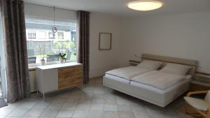 1 dormitorio con cama, lavabo y ventana en Ferienhaus Zum Talblick, en Oberraden