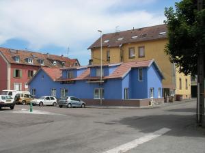 une rangée de maisons avec des voitures garées dans une rue dans l'établissement studios, à Belfort