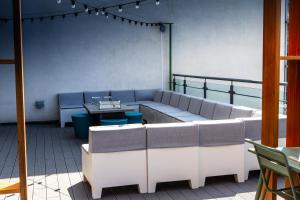 a room with couches and tables on a balcony at Waterfront Southport Hotel in Southport